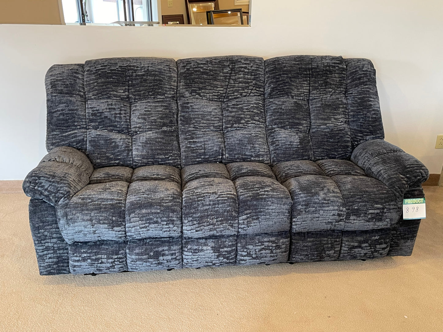 a couch sitting on top of a hard wood floor 