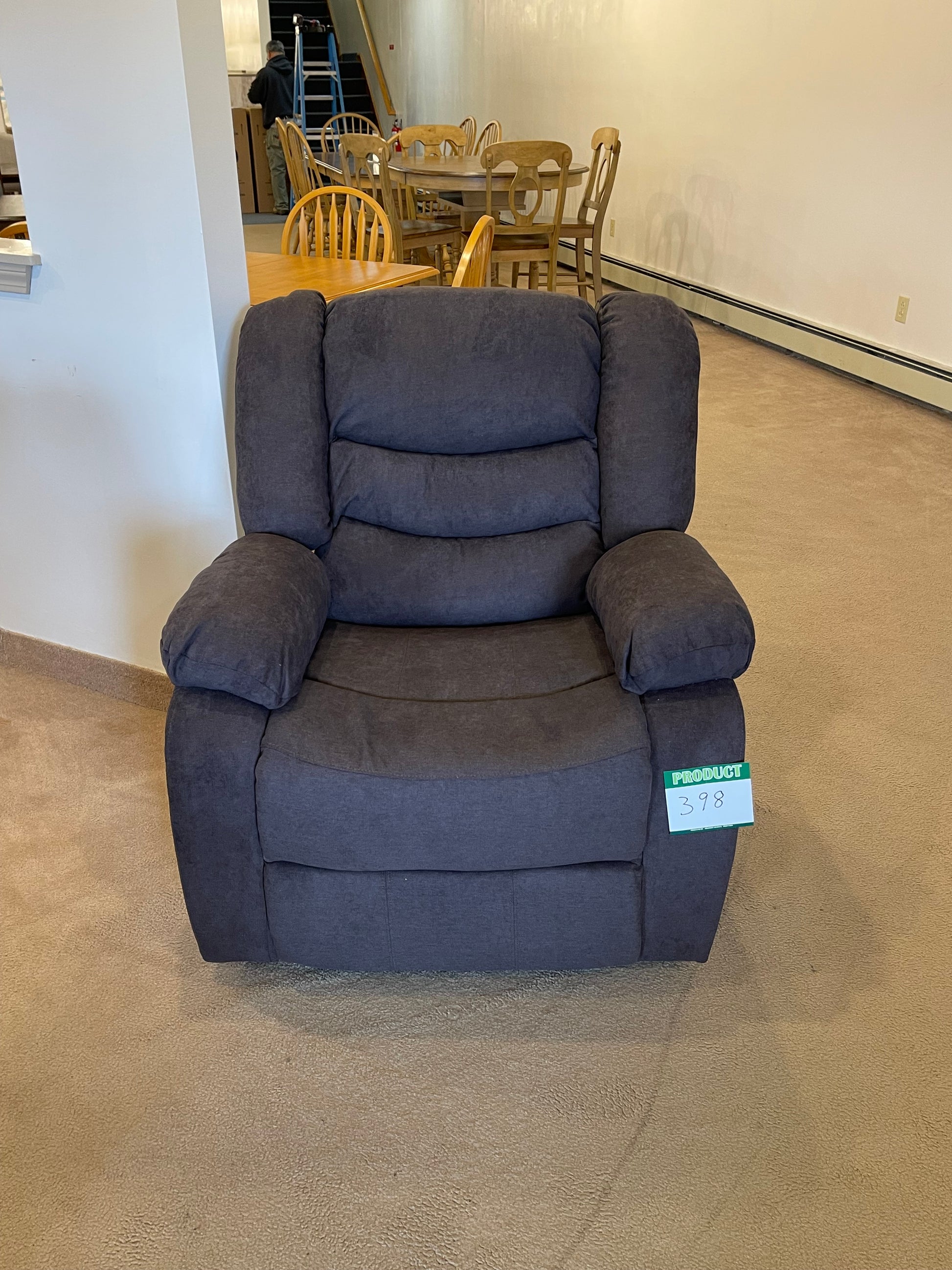 a blue couch sitting on top of a hard wood floor 