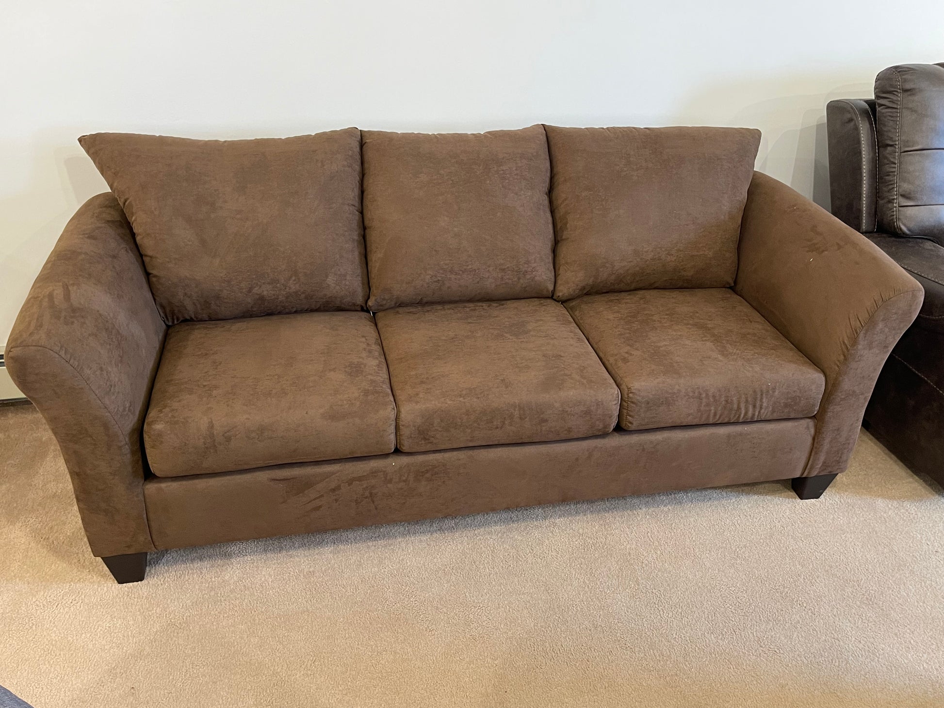 a couch sitting on top of a hard wood floor 